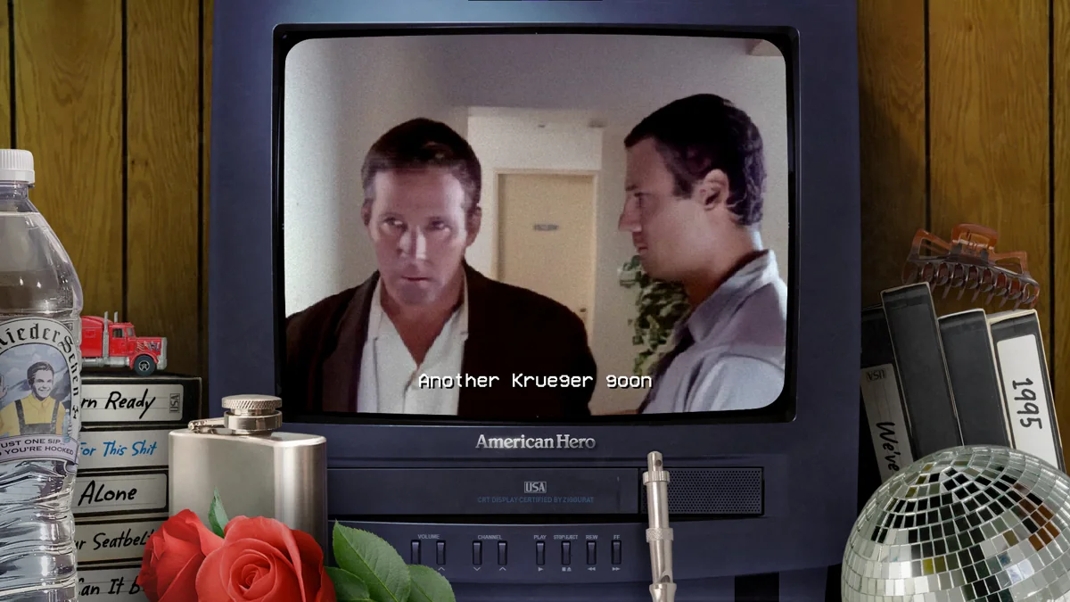 Two men appear on a retro television in American Hero Unrated, with an English caption over the film.