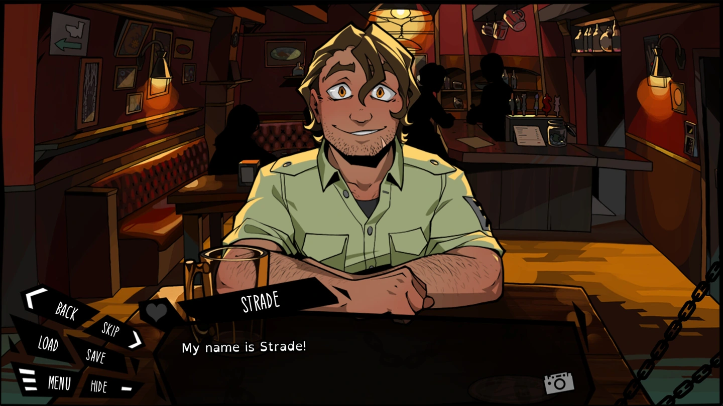 A clothed, smiling Strade introduces himself across a bar table.